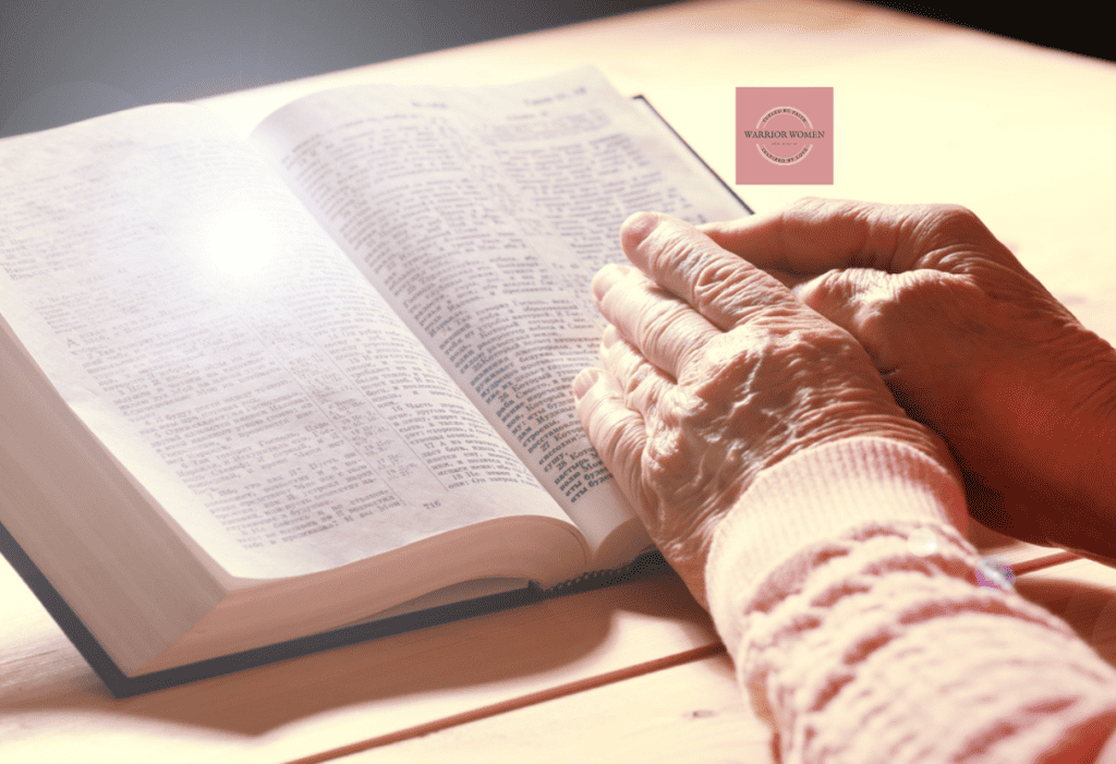 older woman's hand on bible