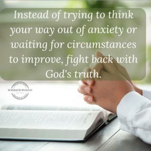 Woman's hand folded in prayer over a Bible for 31 Bible verses for fear and anxiety post.