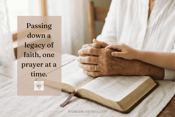Woman's hands clasped in prayer over an open Bible, symbolizing a grandmother's legacy of faith