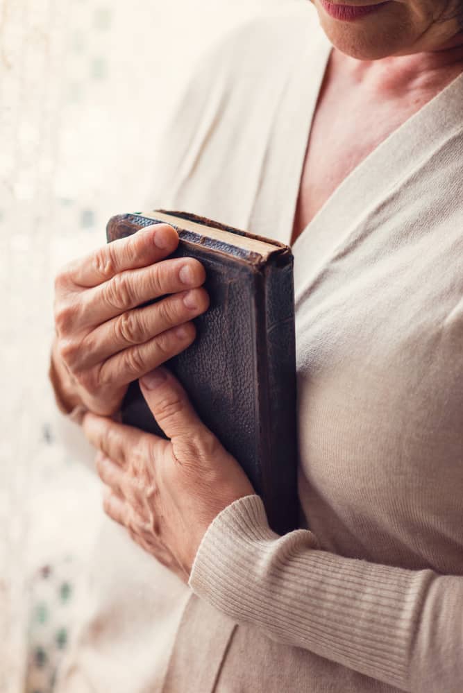 woman holding a Bible